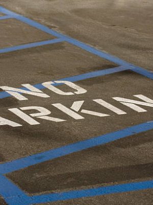 Blue strips and stencil letters mark out no parking zone.